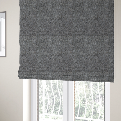 The fabric used to create these Roman blinds is a multi-toned charcoal grey and silver textured upholstery fabric.