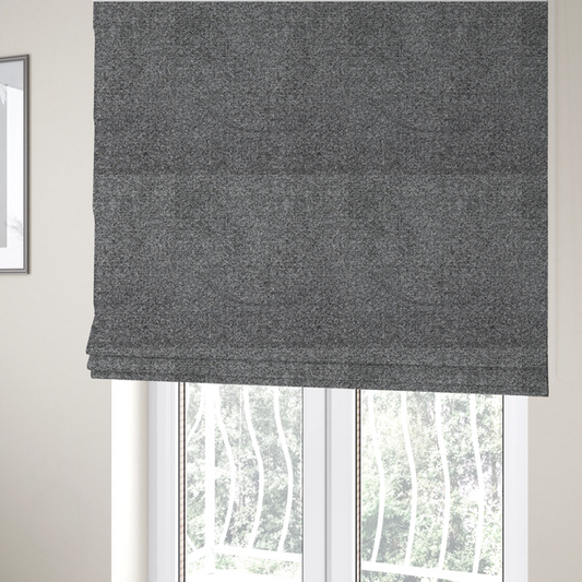 The fabric used to create these Roman blinds is a multi-toned charcoal grey and silver textured upholstery fabric.