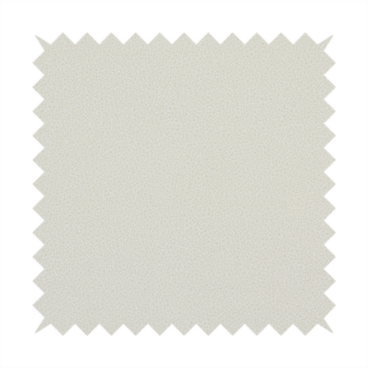 A light beige or off-white suede fabric. The textile features a highly detailed, dense, and uniform embossed pebbled pattern, giving the soft suede material an intricate, tactile texture reminiscent of shagreen.