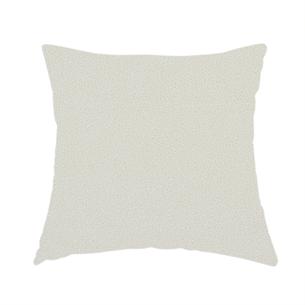 The fabric used to create this handmade cushion is a light beige or off-white suede fabric. The textile features a highly detailed, dense, and uniform embossed pebbled pattern, giving the soft suede material an intricate, tactile texture reminiscent of shagreen.