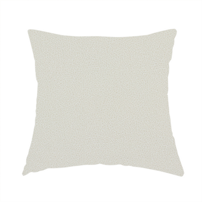 The fabric used to create this handmade cushion is a light beige or off-white suede fabric. The textile features a highly detailed, dense, and uniform embossed pebbled pattern, giving the soft suede material an intricate, tactile texture reminiscent of shagreen.