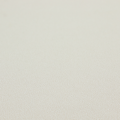 A light beige or off-white suede fabric. The textile features a highly detailed, dense, and uniform embossed pebbled pattern, giving the soft suede material an intricate, tactile texture reminiscent of shagreen.