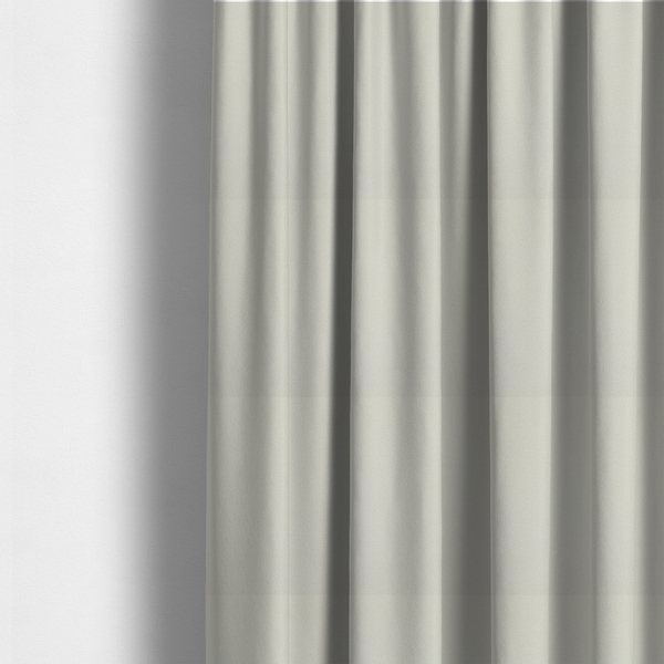 The fabric used to create these made-to-measure curtains is a light beige or off-white suede fabric. The textile features a highly detailed, dense, and uniform embossed pebbled pattern, giving the soft suede material an intricate, tactile texture reminiscent of shagreen.