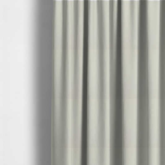 The fabric used to create these made-to-measure curtains is a light beige or off-white suede fabric. The textile features a highly detailed, dense, and uniform embossed pebbled pattern, giving the soft suede material an intricate, tactile texture reminiscent of shagreen.