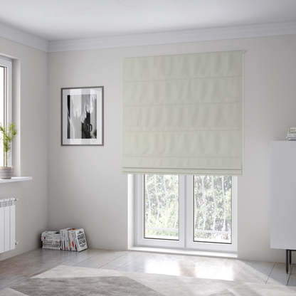 The fabric used to create these Roman blinds is a light beige or off-white suede fabric. The textile features a highly detailed, dense, and uniform embossed pebbled pattern, giving the soft suede material an intricate, tactile texture reminiscent of shagreen.