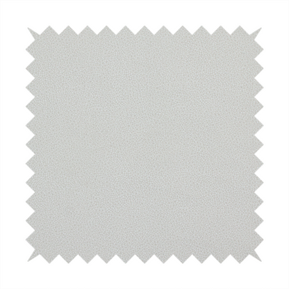 A light grey Merida Suede upholstery fabric. The textile features a highly detailed, dense, and uniform embossed pebbled pattern, giving the soft grey suede material an intricate, tactile shagreen texture.