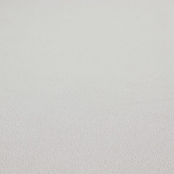 A light grey Merida Suede upholstery fabric. The textile features a highly detailed, dense, and uniform embossed pebbled pattern, giving the soft grey suede material an intricate, tactile shagreen texture.