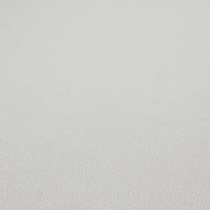A light grey Merida Suede upholstery fabric. The textile features a highly detailed, dense, and uniform embossed pebbled pattern, giving the soft grey suede material an intricate, tactile shagreen texture.
