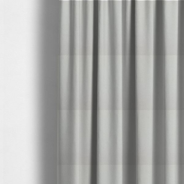 The fabric used to create these made-to-measure curtains is a light grey Merida Suede upholstery fabric. The textile features a highly detailed, dense, and uniform embossed pebbled pattern, giving the soft grey suede material an intricate, tactile shagreen texture.
