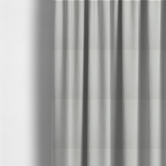 The fabric used to create these made-to-measure curtains is a light grey Merida Suede upholstery fabric. The textile features a highly detailed, dense, and uniform embossed pebbled pattern, giving the soft grey suede material an intricate, tactile shagreen texture.
