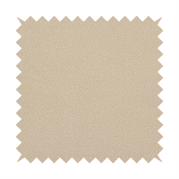 A warm beige or tan Merida Suede upholstery fabric. The textile features a highly detailed, dense, and uniform embossed pebbled pattern, giving the soft suede material an intricate, tactile shagreen texture.