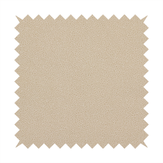 A warm beige or tan Merida Suede upholstery fabric. The textile features a highly detailed, dense, and uniform embossed pebbled pattern, giving the soft suede material an intricate, tactile shagreen texture.
