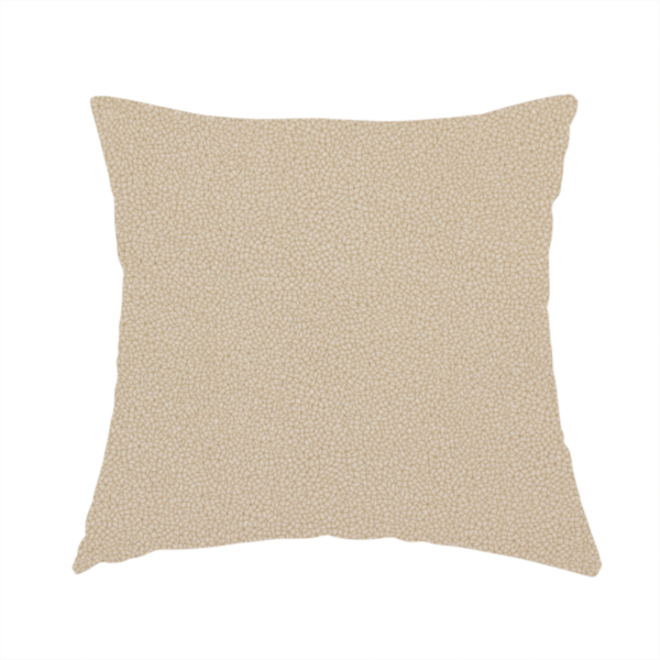 The fabric used to create this handmade cushion is a warm beige or tan Merida Suede upholstery fabric. The textile features a highly detailed, dense, and uniform embossed pebbled pattern, giving the soft suede material an intricate, tactile shagreen texture.