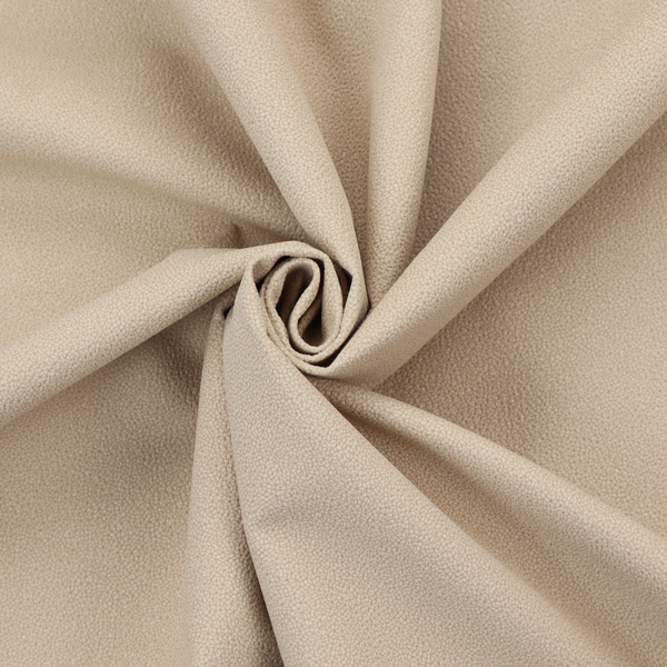 A warm beige or tan Merida Suede upholstery fabric. The textile features a highly detailed, dense, and uniform embossed pebbled pattern, giving the soft suede material an intricate, tactile shagreen texture.