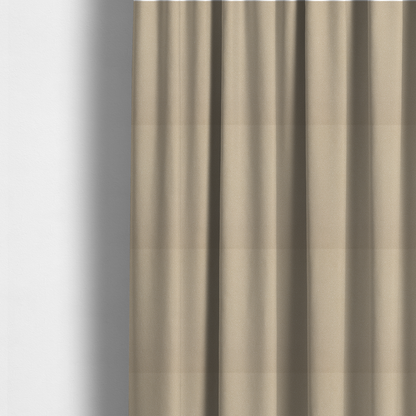 The fabric used to create these made-to-measure curtains is a warm beige or tan Merida Suede upholstery fabric. The textile features a highly detailed, dense, and uniform embossed pebbled pattern, giving the soft suede material an intricate, tactile shagreen texture.