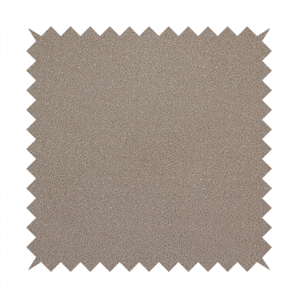 A taupe or dark beige Merida Suede upholstery fabric. The textile features a highly detailed, dense, and uniform embossed pebbled pattern, giving the soft suede material an intricate, tactile shagreen texture.