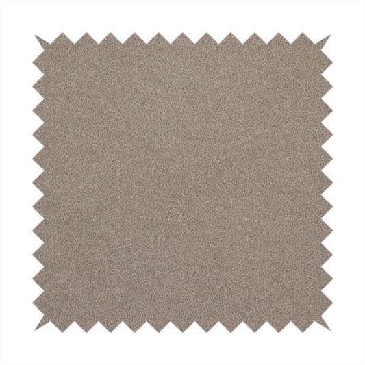 A taupe or dark beige Merida Suede upholstery fabric. The textile features a highly detailed, dense, and uniform embossed pebbled pattern, giving the soft suede material an intricate, tactile shagreen texture.