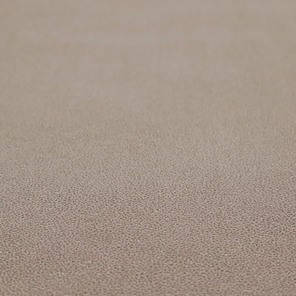 A taupe or dark beige Merida Suede upholstery fabric. The textile features a highly detailed, dense, and uniform embossed pebbled pattern, giving the soft suede material an intricate, tactile shagreen texture.