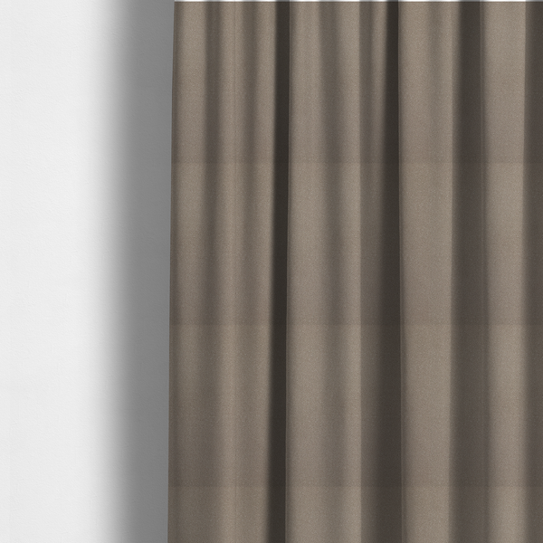 The fabric used to create these made-to-measure curtains is a taupe or dark beige Merida Suede upholstery fabric. The textile features a highly detailed, dense, and uniform embossed pebbled pattern, giving the soft suede material an intricate, tactile shagreen texture.
