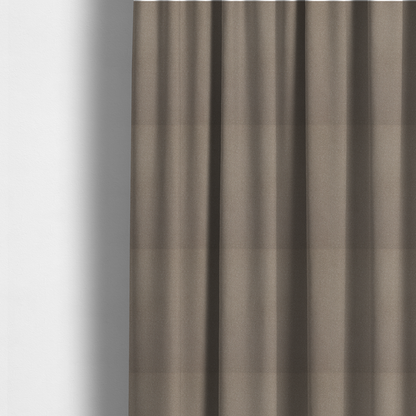 The fabric used to create these made-to-measure curtains is a taupe or dark beige Merida Suede upholstery fabric. The textile features a highly detailed, dense, and uniform embossed pebbled pattern, giving the soft suede material an intricate, tactile shagreen texture.