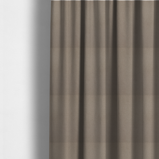 The fabric used to create these made-to-measure curtains is a taupe or dark beige Merida Suede upholstery fabric. The textile features a highly detailed, dense, and uniform embossed pebbled pattern, giving the soft suede material an intricate, tactile shagreen texture.