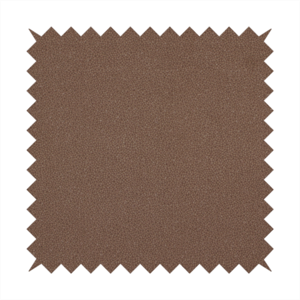 A dark brown or chestnut Merida Suede upholstery fabric. The textile features a highly detailed, dense, and uniform embossed pebbled pattern, giving the soft suede material an intricate, tactile shagreen texture.