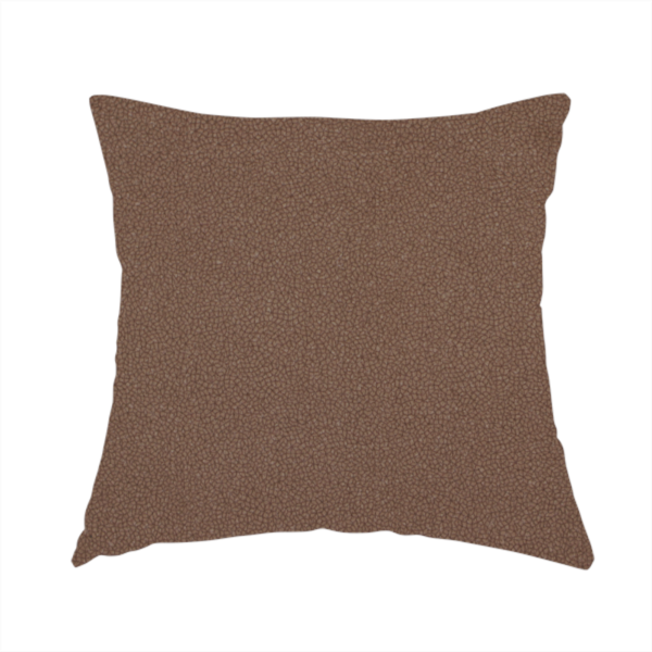 The fabric used to create this handmade cushion is a dark brown or chestnut Merida Suede upholstery fabric. The textile features a highly detailed, dense, and uniform embossed pebbled pattern, giving the soft suede material an intricate, tactile shagreen texture.