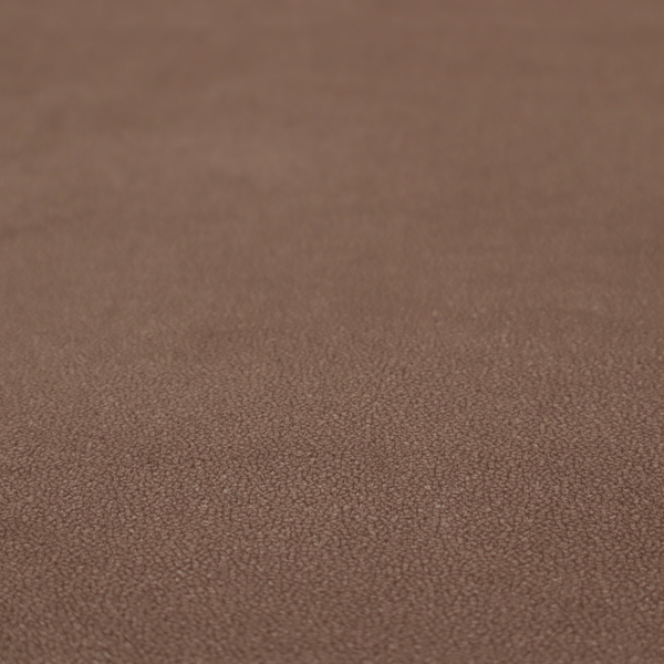 A dark brown or chestnut Merida Suede upholstery fabric. The textile features a highly detailed, dense, and uniform embossed pebbled pattern, giving the soft suede material an intricate, tactile shagreen texture.