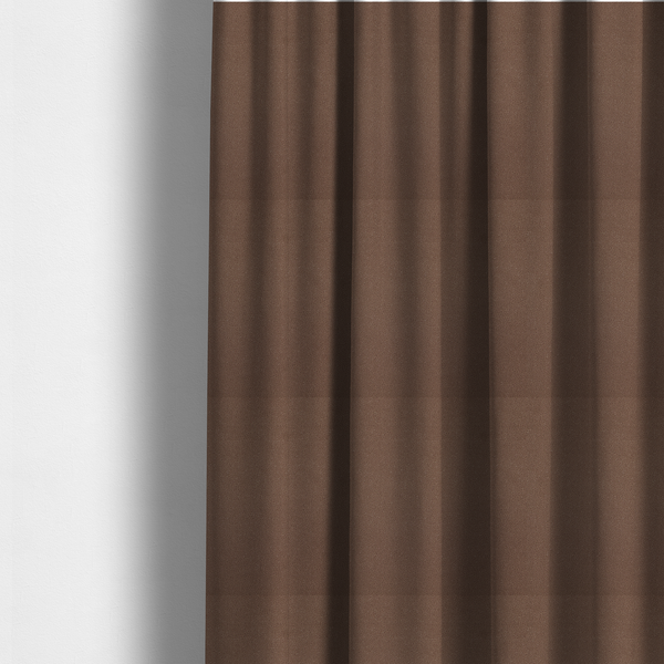 The fabric used to create these made-to-measure curtains is a dark brown or chestnut Merida Suede upholstery fabric. The textile features a highly detailed, dense, and uniform embossed pebbled pattern, giving the soft suede material an intricate, tactile shagreen texture.