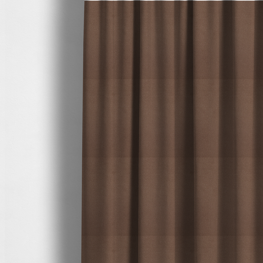 The fabric used to create these made-to-measure curtains is a dark brown or chestnut Merida Suede upholstery fabric. The textile features a highly detailed, dense, and uniform embossed pebbled pattern, giving the soft suede material an intricate, tactile shagreen texture.