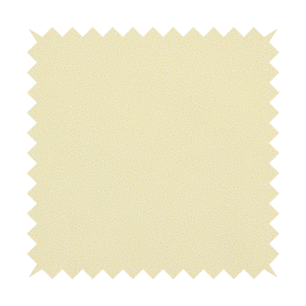 A light cream or soft ivory Merida Suede upholstery fabric. The textile features a highly detailed, dense, and uniform embossed pebbled pattern, giving the soft suede material an intricate, tactile shagreen texture.