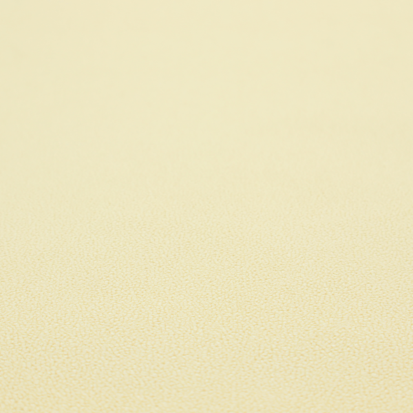 A light cream or soft ivory Merida Suede upholstery fabric. The textile features a highly detailed, dense, and uniform embossed pebbled pattern, giving the soft suede material an intricate, tactile shagreen texture.