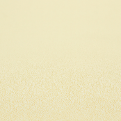 A light cream or soft ivory Merida Suede upholstery fabric. The textile features a highly detailed, dense, and uniform embossed pebbled pattern, giving the soft suede material an intricate, tactile shagreen texture.