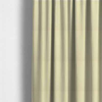 The fabric used to create these made-to-measure curtains is a light cream or soft ivory Merida Suede upholstery fabric. The textile features a highly detailed, dense, and uniform embossed pebbled pattern, giving the soft suede material an intricate, tactile shagreen texture.
