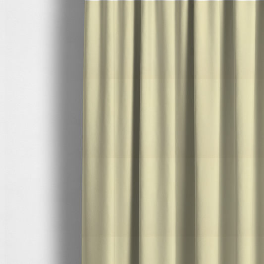 The fabric used to create these made-to-measure curtains is a light cream or soft ivory Merida Suede upholstery fabric. The textile features a highly detailed, dense, and uniform embossed pebbled pattern, giving the soft suede material an intricate, tactile shagreen texture.