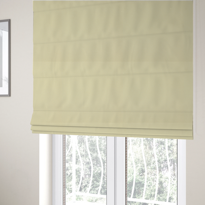 The fabric used to create these Roman blinds is a light cream or soft ivory Merida Suede upholstery fabric. The textile features a highly detailed, dense, and uniform embossed pebbled pattern, giving the soft suede material an intricate, tactile shagreen texture.