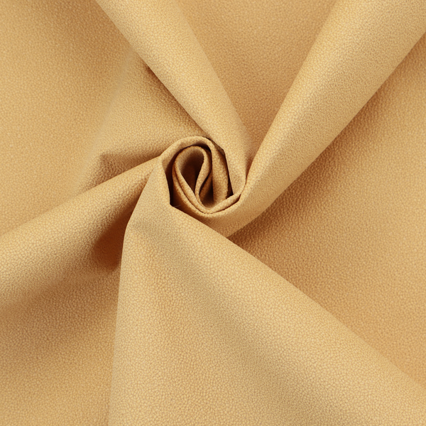 A warm ochre or golden yellow Merida Suede upholstery fabric. The textile features a highly detailed, dense, and uniform embossed pebbled pattern, giving the soft suede material an intricate, tactile shagreen texture.