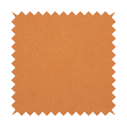 A bright orange or tangerine Merida Suede upholstery fabric. The textile features a highly detailed, dense, and uniform embossed pebbled pattern, giving the soft suede material an intricate, tactile shagreen texture.