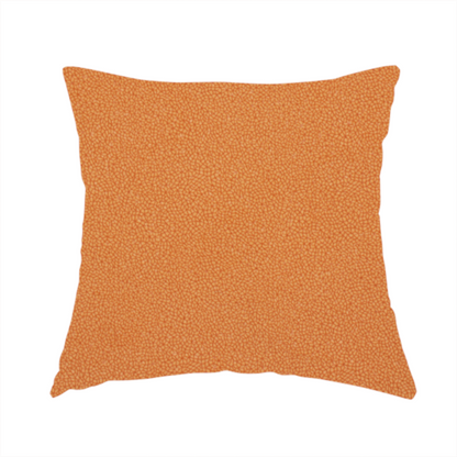 The fabric used to create this handmade cushion is a bright orange or tangerine Merida Suede upholstery fabric. The textile features a highly detailed, dense, and uniform embossed pebbled pattern, giving the soft suede material an intricate, tactile shagreen texture.