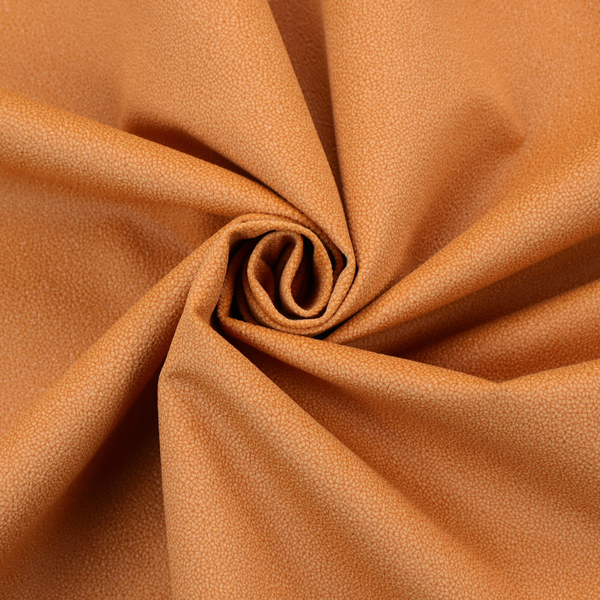 A bright orange or tangerine Merida Suede upholstery fabric. The textile features a highly detailed, dense, and uniform embossed pebbled pattern, giving the soft suede material an intricate, tactile shagreen texture.