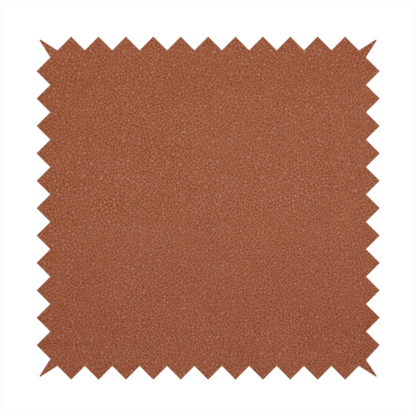A warm terracotta or rust orange Merida Suede upholstery fabric. The textile features a highly detailed, dense, and uniform embossed pebbled pattern, giving the soft suede material an intricate, tactile shagreen texture.