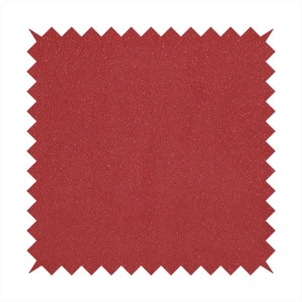 A rich crimson or deep red Merida Suede upholstery fabric. The textile features a highly detailed, dense, and uniform embossed pebbled pattern, giving the soft suede material an intricate, tactile shagreen texture.