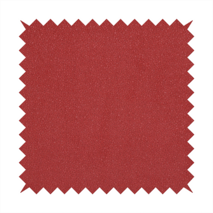 A rich crimson or deep red Merida Suede upholstery fabric. The textile features a highly detailed, dense, and uniform embossed pebbled pattern, giving the soft suede material an intricate, tactile shagreen texture.