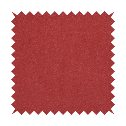 A rich crimson or deep red Merida Suede upholstery fabric. The textile features a highly detailed, dense, and uniform embossed pebbled pattern, giving the soft suede material an intricate, tactile shagreen texture.