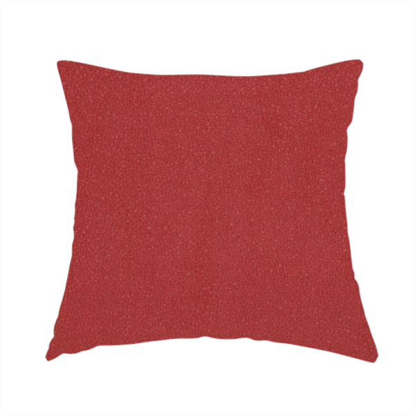 The fabric used to create this handmade cushion is a rich crimson or deep red Merida Suede upholstery fabric. The textile features a highly detailed, dense, and uniform embossed pebbled pattern, giving the soft suede material an intricate, tactile shagreen texture.
