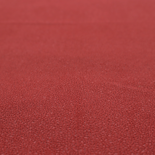 A rich crimson or deep red Merida Suede upholstery fabric. The textile features a highly detailed, dense, and uniform embossed pebbled pattern, giving the soft suede material an intricate, tactile shagreen texture.
