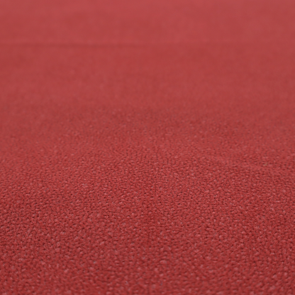 A rich crimson or deep red Merida Suede upholstery fabric. The textile features a highly detailed, dense, and uniform embossed pebbled pattern, giving the soft suede material an intricate, tactile shagreen texture.