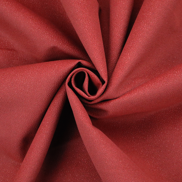 A rich crimson or deep red Merida Suede upholstery fabric. The textile features a highly detailed, dense, and uniform embossed pebbled pattern, giving the soft suede material an intricate, tactile shagreen texture.
