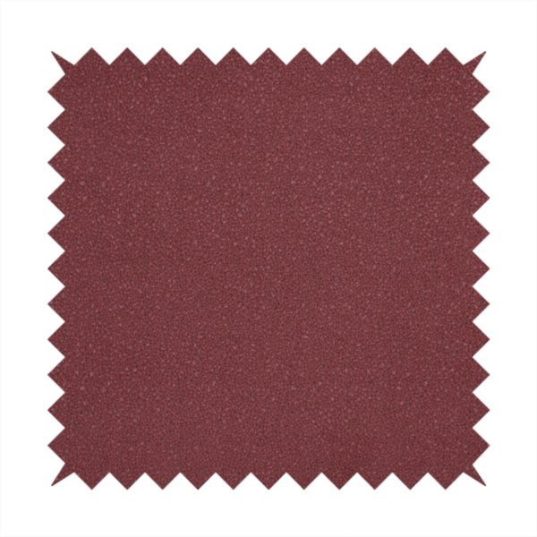 A suede fabric in a deep, muted maroon or burgundy colour.
