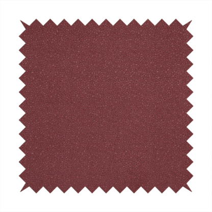 A suede fabric in a deep, muted maroon or burgundy colour.